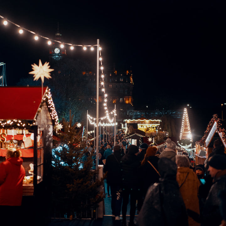 Child admiring Christmas decorations at a market stall