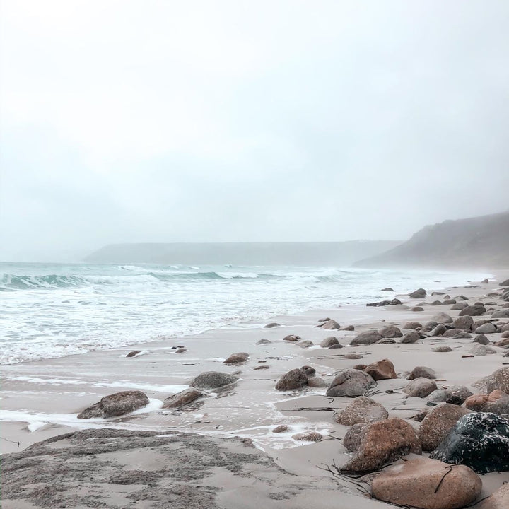A wintery beach image with a coastal view on a misty day